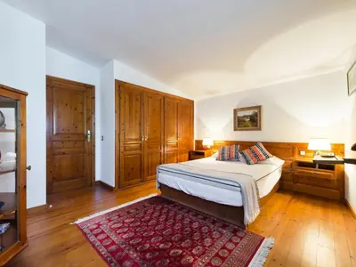 a bedroom with a bed and a red rug at Cal Tomas in Castellet