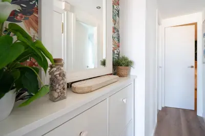 a mirror on top of a white cabinet in a hallway at Castelldefels - Apartment - Sleeps 4 - Beach Side in Castelldefels