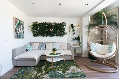 a living room with a couch and a chair at Castelldefels - Apartment - Sleeps 4 - Beach Side in Castelldefels