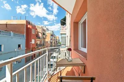 a balcony with a table and a vase of flowers at 1º Apartamento 3 hab 15' Barcelona centro 8' Playa in Sant Adria de Besos