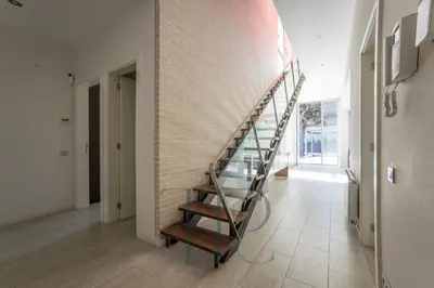 a spiral staircase in a room with a brick wall at Gavamar in Gavà