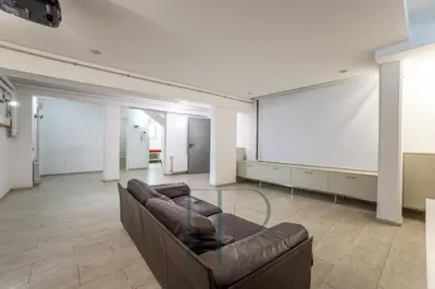 a large room with a couch and a projection screen at Gavamar in Gavà