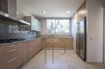 a kitchen with a glass table in the middle of it at Gavamar in Gavà