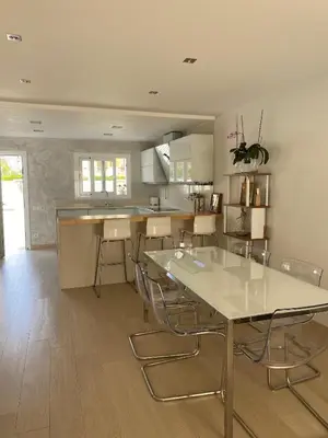a kitchen with tables and chairs in a room at House 50meters from the beach in Cunit