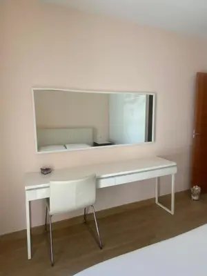 a white desk with a mirror and a chair at House 50meters from the beach in Cunit