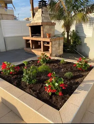 a garden with a brick oven in a yard at House 50meters from the beach in Cunit