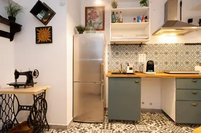 a kitchen with a stainless steel refrigerator in a room at Estudios a 10' caminando de la playa y a 20' de Barcelona Centro in Sant Adria de Besos