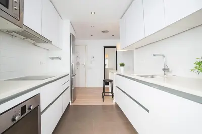 a kitchen with white cabinets and a sink at Tendency Apartments 12 Penthouse in Barcelona