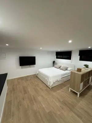 a bedroom with a bed and a flat screen tv at Apartamento a 5 minutos de Sitges in Sant Pere de Ribes