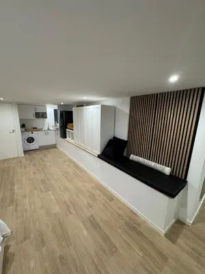 a living room with a couch and a kitchen at Apartamento a 5 minutos de Sitges in Sant Pere de Ribes