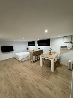 a bedroom with a bed and a desk and a table at Apartamento a 5 minutos de Sitges in Sant Pere de Ribes