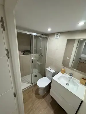 a bathroom with a toilet and a shower and a sink at Apartamento a 5 minutos de Sitges in Sant Pere de Ribes