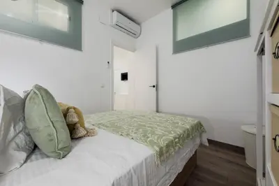 a bedroom with a bed with a teddy bear on it at Bonito Apartamento en Ronda Sant Pau in Barcelona