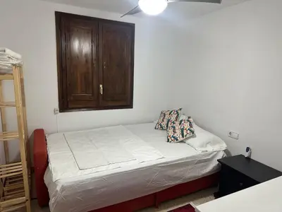 a small bed in a room with a wooden cabinet at Vallromanes House of Peace and Rest in Vallromanas