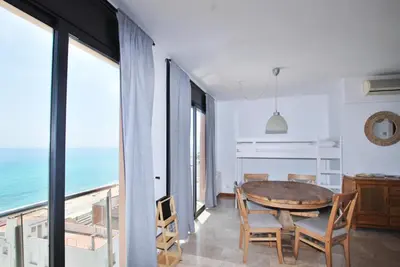 a patio with a table and chairs on a balcony at Waves and sky in Montgat