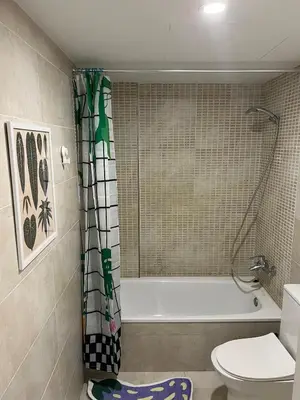 a bathroom with a tub and a toilet and a shower at Artistic beach apartment in Cunit