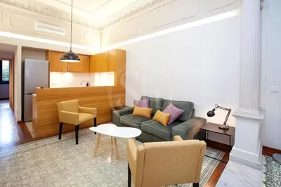 a living room with a couch and a table at Elegant and cozy retreat in Barcelona
