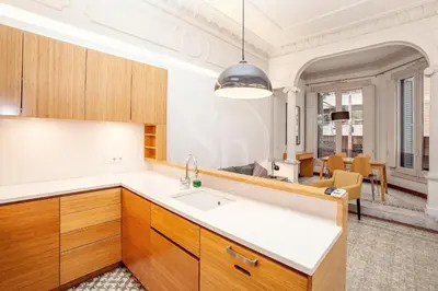 a kitchen with wooden cabinets and a sink at Elegant and cozy retreat in Barcelona