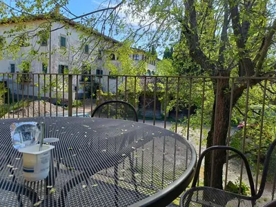 a table with a cup of coffee sitting on a patio at El Freixe de l'Ylla in Els Hostalets