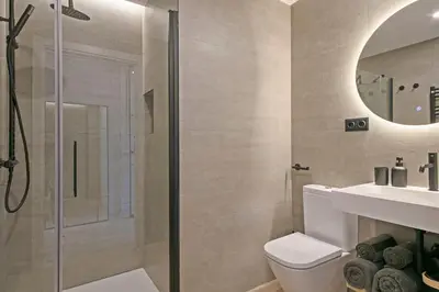 a bathroom with a shower and a toilet and a sink at Joan Austria 2 Bedroom Apartment in Barcelona