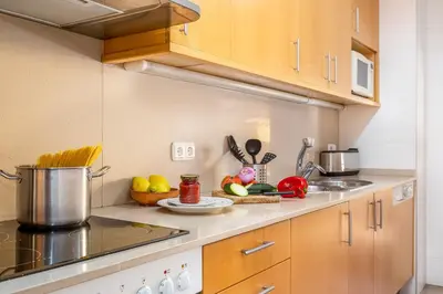 a kitchen with a sink and a stove top oven at Lets Holidays Terrace Barcelona in Barcelona