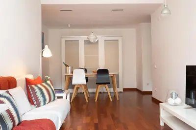a living room with a white couch and a table at Lets Holidays Terrace Barcelona in Barcelona