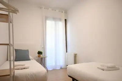 a bedroom with two beds and a window at Homenfun Barcelona Avenida Diagonal in Barcelona