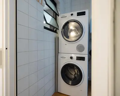 a washing machine and a dryer in a bathroom at Stay U-nique Apartments Villarroel II in Barcelona