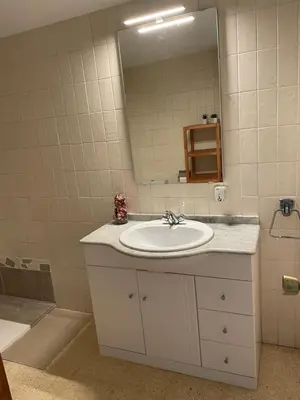 a bathroom with a sink and a mirror at Apartament a Arenys de Mar in Arenys de Mar