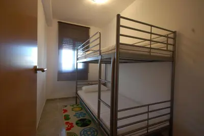 a room with two bunk beds in a room at Lets Holidays New Flat Beachfront In Castelldefels in Castelldefels