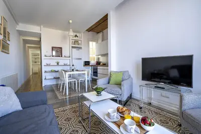 a living room with a couch and a tv at Habitat Apartments Vila in Barcelona