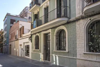 an empty street in a city with buildings at Habitat Apartments Vila in Barcelona