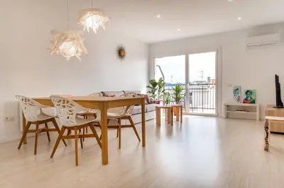 a living room with a dining room table and chairs at Apartamento artístico Vilanova in Vilanova i la Geltrú