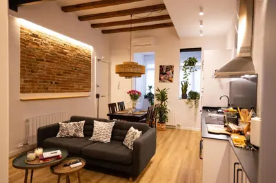 a living room with a couch and a table at Poble Sec Charming Apartment in Barcelona
