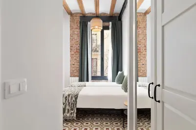 a room with a bed in front of a window at Poble Sec Charming Apartment in Barcelona