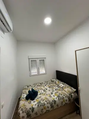 a bedroom with a bed with a teddy bear on it at Modern apartment Barcelona in Badalona