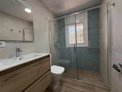a bathroom with a shower and a toilet and a sink at Charming Catalan Villa with Pool & Views in Cunit
