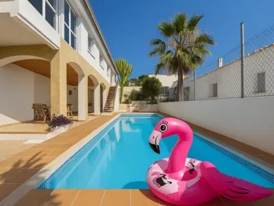 a pink flamingo float in a swimming pool at Charming Catalan Villa with Pool & Views in Cunit