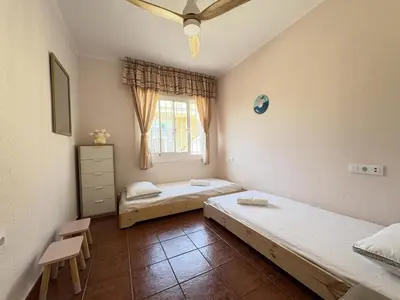 a bedroom with two beds and a window at Charming Catalan Villa with Pool & Views in Cunit