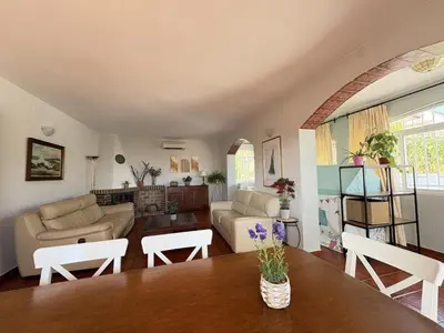a living room with a table and a couch at Charming Catalan Villa with Pool & Views in Cunit