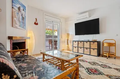 a living room with a coffee table and a flat screen tv at Hauzify I Casa Ribera in Cunit