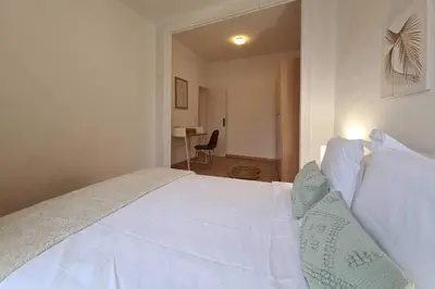 a bedroom with a large white bed with white pillows at 21ARA1085- Fabulous 4BR apartment in Ciutat Vella in Barcelona