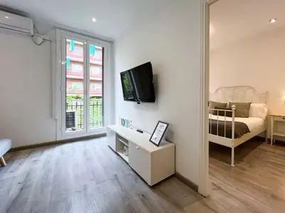 a living room with a tv on a wall at Stay Unique Apartments Mallorca III in Barcelona