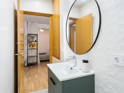 a bathroom with a sink and a mirror at Apartments near the airport in Cornellà de Llobregat