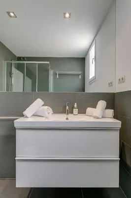 a bathroom with a sink and a mirror at Rambla Catalunya Sky in Barcelona