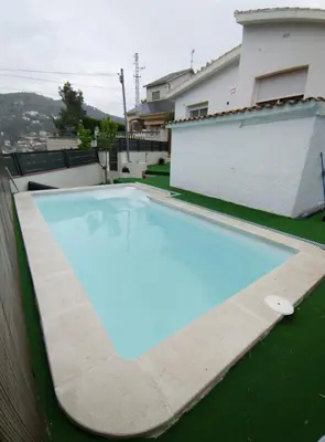 a swimming pool in the backyard of a house at Estrella Relax in Vallirana