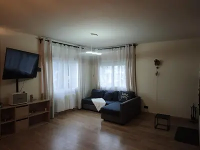 a living room with a couch and a flat screen tv at Estrella Relax in Vallirana