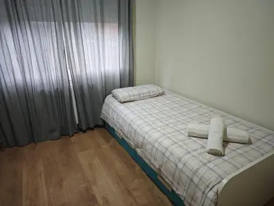 a bedroom with a bed with two towels on it at Estrella Relax in Vallirana