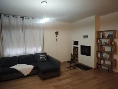 a living room with a couch and a tv at Estrella Relax in Vallirana
