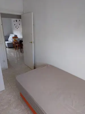 a white bed in a room with a bedroom at Dormir sleep Comidad 100 in Barcelona